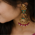 Woman wearing a blue saree with a pink blouse, showcasing traditional Peacock Jhumka 