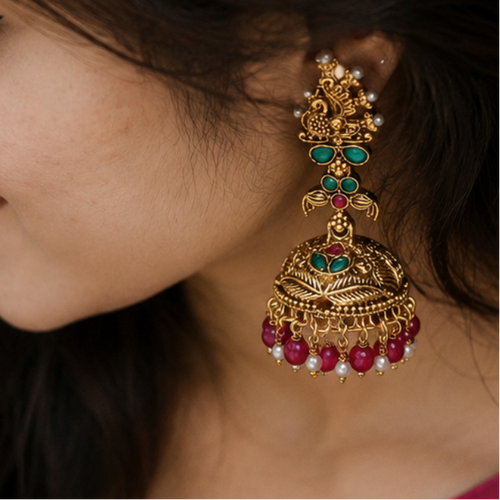 Woman wearing a blue saree with a pink blouse, showcasing traditional Peacock Jhumka 